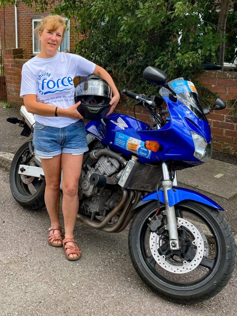 Kate West alongside her motorbike ahead of her round Britain ride