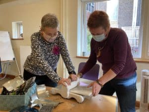 Rachel Stewart and Rachel Toll press out decorations