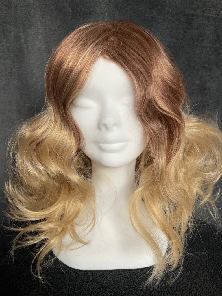 Blonde with red roots and a basic wig cap